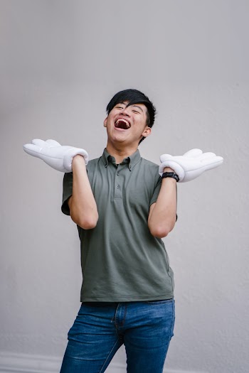 Man Standing Against Gray Wall