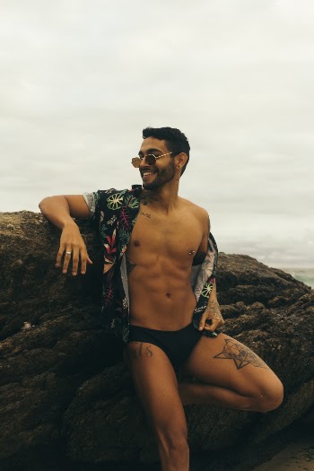 Man Standing Against the Rock at the Seashore