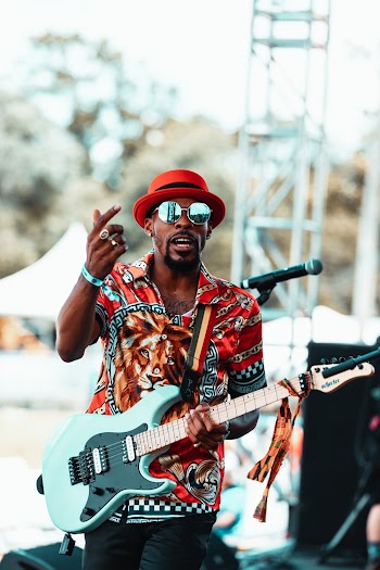 Man Standing and Playing Electric Guitar