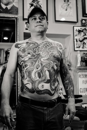 Man Standing and Showing His Body Tattoo