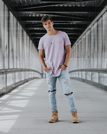 Man Standing And Smiling In The Hallway