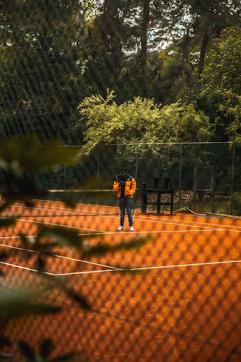 Man Standing at Brown Field