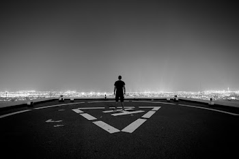 Man Standing at the Peak of Helicopter Landing