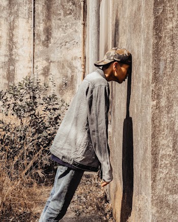 Man Standing Behind Concrete Wall