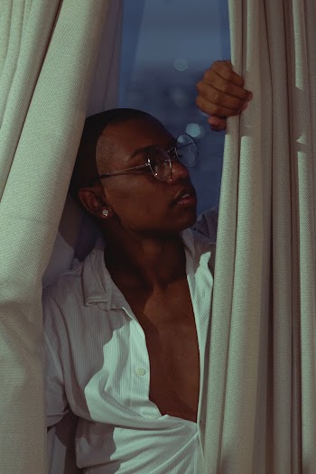 Man Standing Behind Curtain