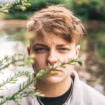 Man Standing Behind Leaves