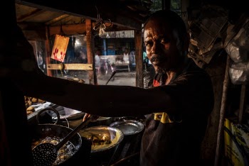 Man Standing Behind Stall