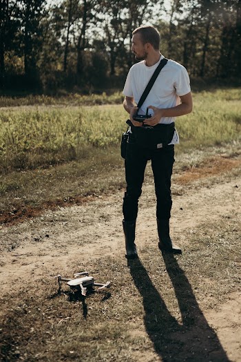 Man Standing Beside A Drone