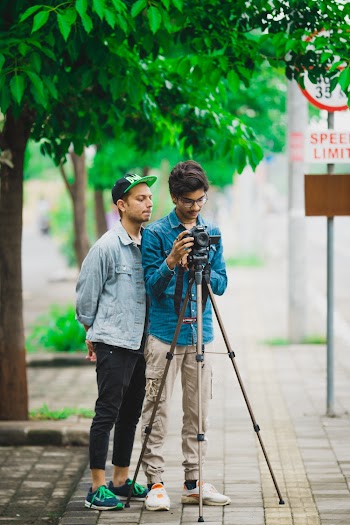 Man Standing Beside Another Man Who Takes Photo 