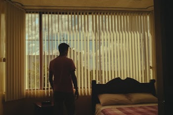 Man Standing Beside Bed 