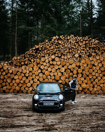 Man Standing Beside Black Mini Cooper