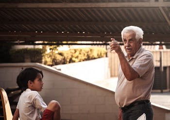 Man Standing Beside Boy While Pointing From The Distance