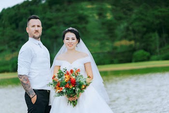 Man Standing Beside Bride Holding Bouquet Of Flowers