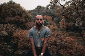 man standing beside brown and green leafed plants