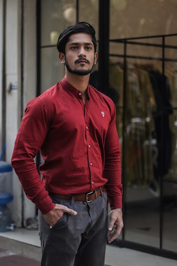 Man Standing Beside Clear Glass Window