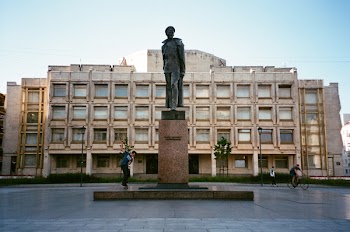 Man Standing Beside Concrete Statue