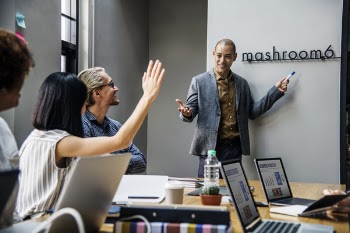 Man Standing Beside Desk