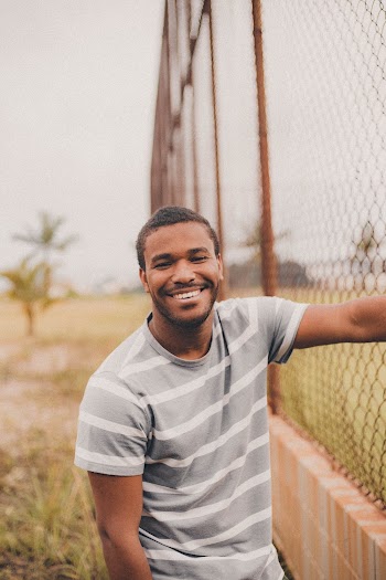 Man Standing Beside Fence