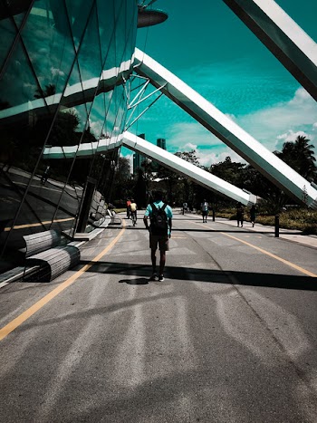 Man Standing Beside Glass Curtain