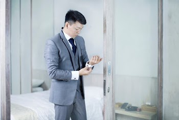 Man Standing Beside Glass Wall