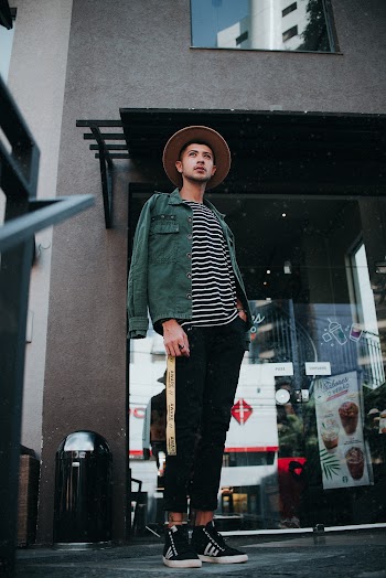 Man Standing Beside Glass Wall Building