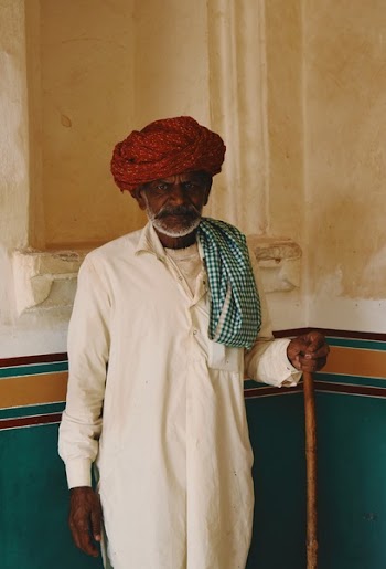 Man Standing Beside Green and White Wall
