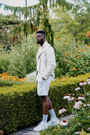 Man Standing Beside Green Leafed Plants