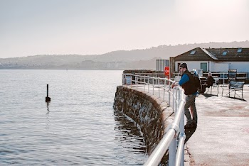 Man Standing Beside Metal Rails