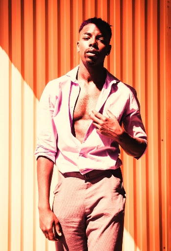 Man Standing Beside Orange Wall