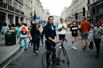 Man Standing Beside Park Bicycle