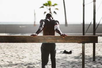 Man Standing Beside Rail