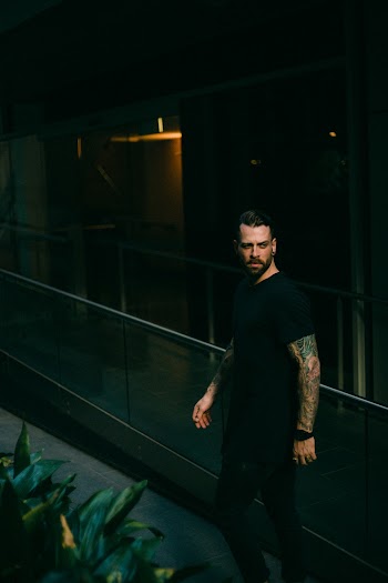 Man Standing Beside Railing
