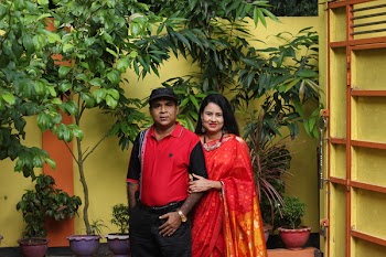 Man Standing Beside Smiling Woman Near Potted Green Leafed Plants
