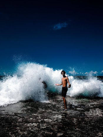 Man Standing Beside Splashing Water