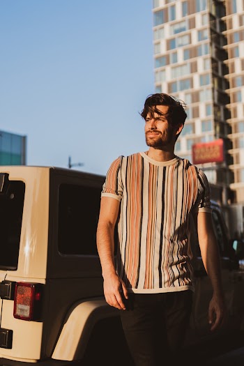 Man Standing Beside Vehicle