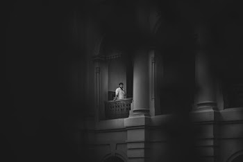 man standing beside wall
