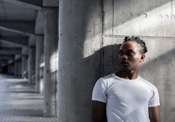 Man Standing Beside Wall