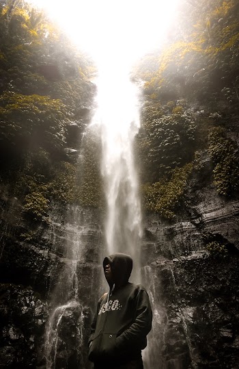 Man Standing Beside Waterfalls