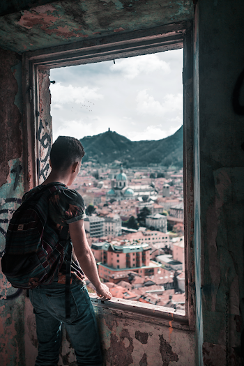 Man Standing Beside Window