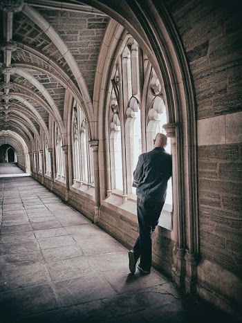 man standing beside window