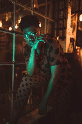 Man Standing Beside Window