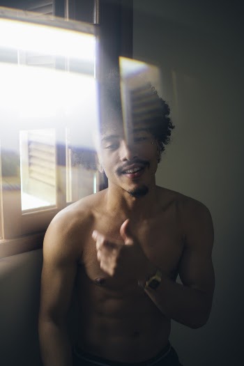 Man Standing Beside Window