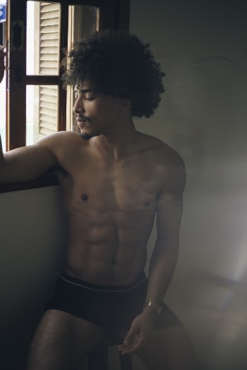 Man Standing Beside Window