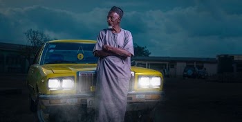 man standing beside yellow car