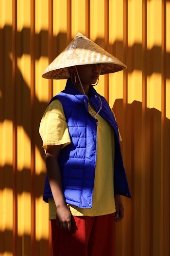 Man Standing Beside Yellow Wall