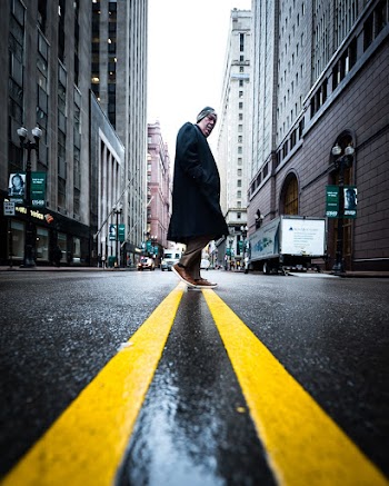 Man Standing Between Buildings