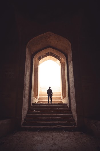 Man Standing Between Stairway on Pathway