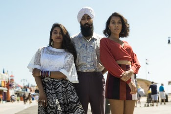 Man Standing Between Two Women
