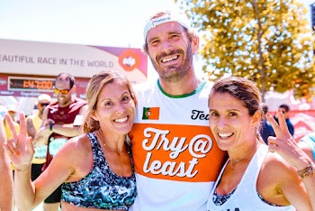 Man Standing Between Two Women