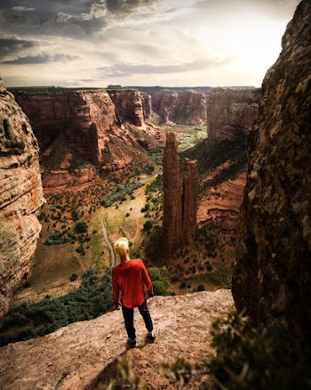 Man Standing By A Rock Cliff